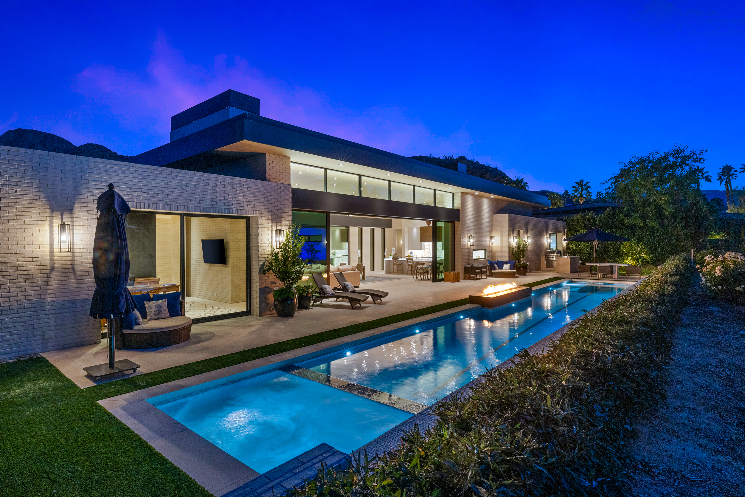 Indoor-outdoor living room with expansive glass walls